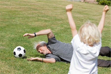 seniors sport competition - grandfather and child playing football Stock Photo - Premium Royalty-Free, Code: 649-03297273