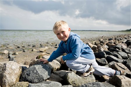 Boy walking over stones Stock Photo - Premium Royalty-Free, Code: 649-03297558