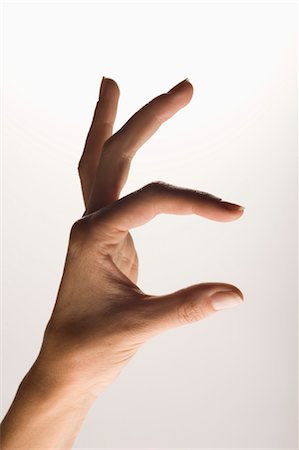 Hand measuring or indicating an object Foto de stock - Sin royalties Premium, Código: 649-03297629