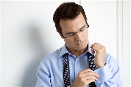 A business man doing up his cuffs Stock Photo - Premium Royalty-Free, Code: 649-03297709