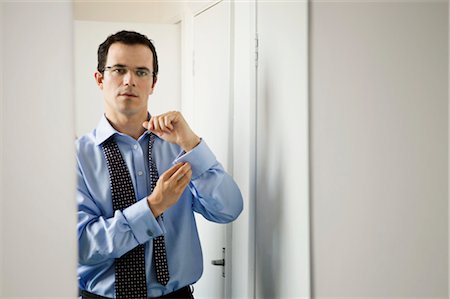 A business man doing up his cuffs Stock Photo - Premium Royalty-Free, Code: 649-03297710