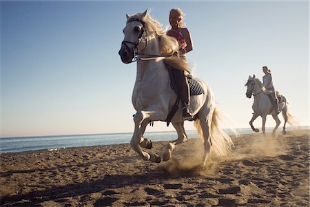 spain beaches adult women pic - Two women riding horses on beach Stock Photo - Premium Royalty-Free, Code: 649-03297742