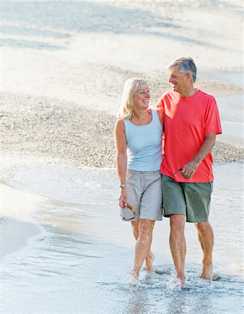 spain beaches adult women pic - Senior couple walk along the beach Stock Photo - Premium Royalty-Free, Code: 649-03291880