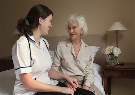 senior care inside assistance - Nurse holding the hand of elderly woman Stock Photo - Premium Royalty-Free, Code: 649-03292154