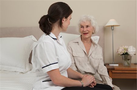 patient happy in bed - Nurse holding hand of elderly woman Stock Photo - Premium Royalty-Free, Code: 649-03292156
