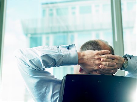 Business man looking through window Stock Photo - Premium Royalty-Free, Code: 649-03292194