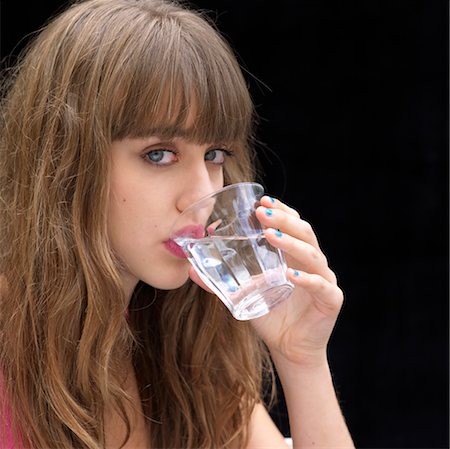 Young woman drinking water Stock Photo - Premium Royalty-Free, Code: 649-03292537