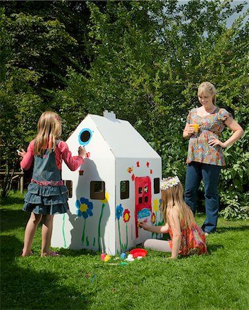 simsearch:649-03818266,k - Girls painting a cardboard wendy house Stock Photo - Premium Royalty-Free, Code: 649-03292587