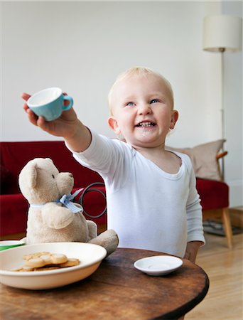 A boy toddler holding out a tea cup Stock Photo - Premium Royalty-Free, Code: 649-03292613