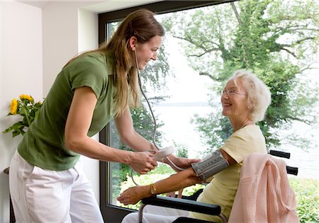 patient and nurse and happy - nurse taking woman's blood pressure Stock Photo - Premium Royalty-Free, Code: 649-03292665