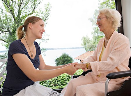 woman and senior woman holding hands Stock Photo - Premium Royalty-Free, Code: 649-03292671