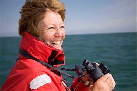 portsmouth - Woman with binoculars by ocean Stock Photo - Premium Royalty-Free, Code: 649-03292843