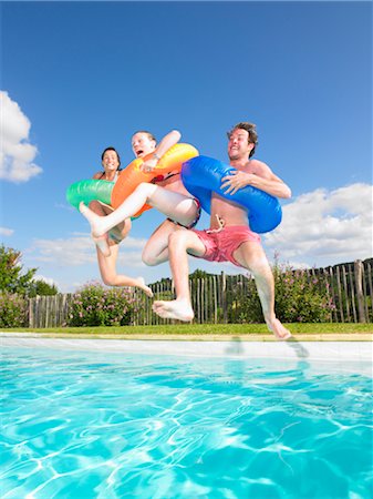 friends in the swimming pool - people jumping into pool Stock Photo - Premium Royalty-Free, Code: 649-03293709