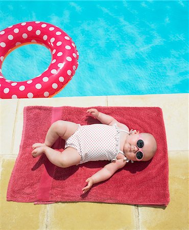 relaxing on innertube - baby sunbathing Stock Photo - Premium Royalty-Free, Code: 649-03293701