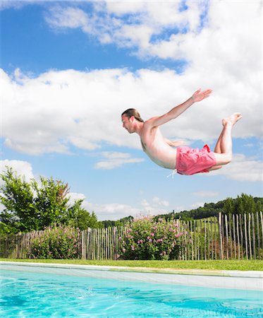 profile of person diving into pool - young man diving Stock Photo - Premium Royalty-Free, Code: 649-03293703