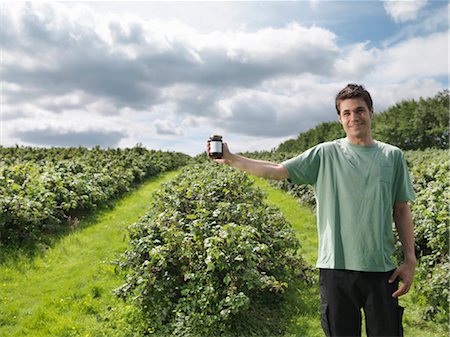 Man With Blackcurrant Jam In Field Stock Photo - Premium Royalty-Free, Code: 649-03293971
