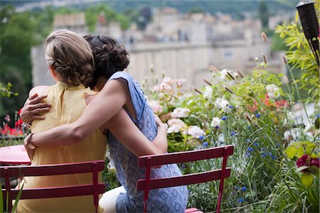 two women hugging on balcony Stock Photo - Premium Royalty-Free, Code: 649-03362757