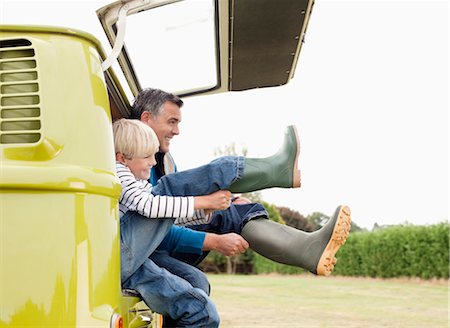 family outdoor activities - Father and son putting on boots Stock Photo - Premium Royalty-Free, Code: 649-03417590