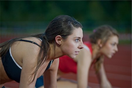 race start - 2 female athletes in starting blocks Stock Photo - Premium Royalty-Free, Code: 649-03417710