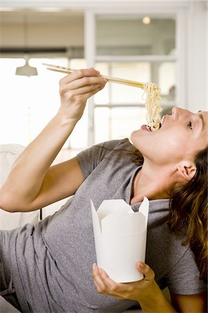 eating takeout - Woman at home Stock Photo - Premium Royalty-Free, Code: 649-03418038