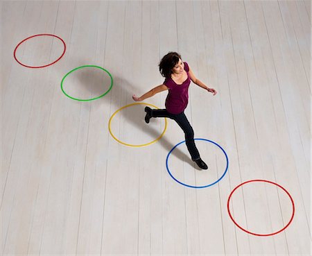 elevated view of a confident businesswoman - Woman jumping over circles Stock Photo - Premium Royalty-Free, Code: 649-03446891