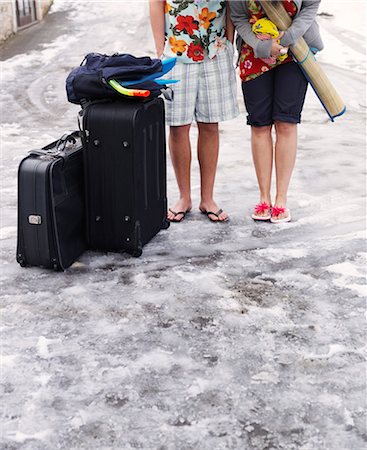 Couple standing in snow with suitcases Stock Photo - Premium Royalty-Free, Code: 649-03447559