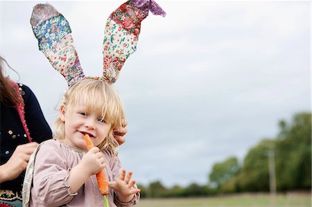 Little girl nibbling with bunny ears Stock Photo - Premium Royalty-Free, Code: 649-03447762