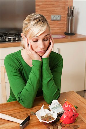 Beautiful woman and broken piggy bank Stock Photo - Premium Royalty-Free, Code: 649-03447877