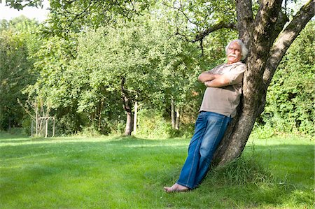 portrait senior man full length - Grandfather is leaning against a tree Stock Photo - Premium Royalty-Free, Code: 649-03448406