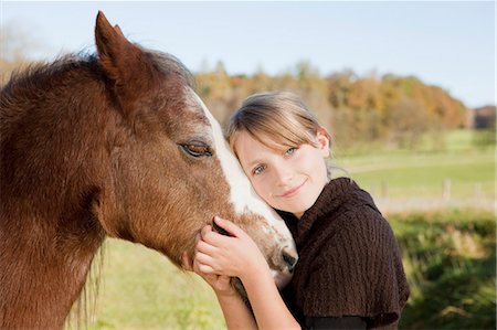 female pony images - Girl stroking a horse Stock Photo - Premium Royalty-Free, Code: 649-03448585