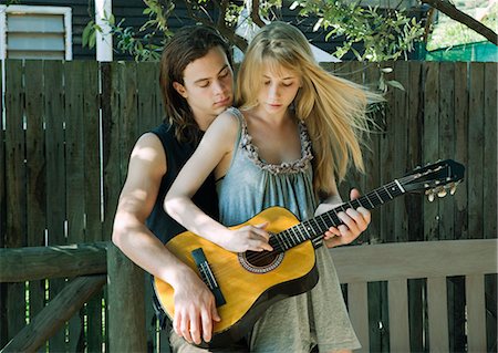 simsearch:6122-07704043,k - Girl playing guitar with young man Stock Photo - Premium Royalty-Free, Code: 649-03465625