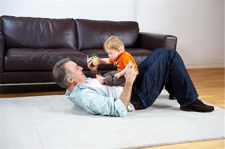 dad baby playing toy - Father and baby playing on rug Stock Photo - Premium Royalty-Free, Code: 649-03465794