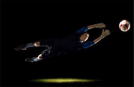 soccer player determined - Goalkeeper diving for ball Stock Photo - Premium Royalty-Free, Code: 649-03466208