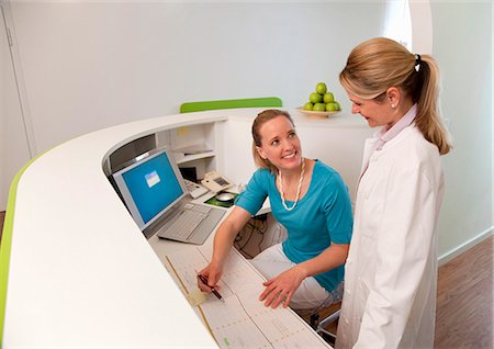 Doctor and Receptionist in surgery Stock Photo - Premium Royalty-Free, Code: 649-03487196