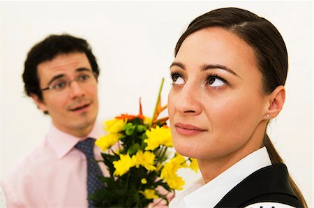 refuse - Women ignores man offering flowers Stock Photo - Premium Royalty-Free, Code: 649-03487757