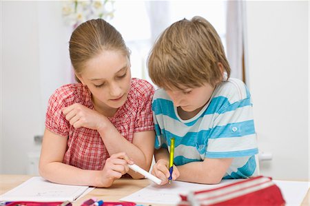 Garçon et fille à faire leurs devoirs Photographie de stock - Premium Libres de Droits, Code: 649-03510747