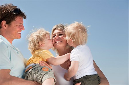 free images of men holding baby - Family with twins kissing Stock Photo - Premium Royalty-Free, Code: 649-03511032