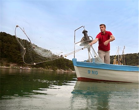 Fisherman fishing with net Stock Photo - Premium Royalty-Free, Code: 649-03511129