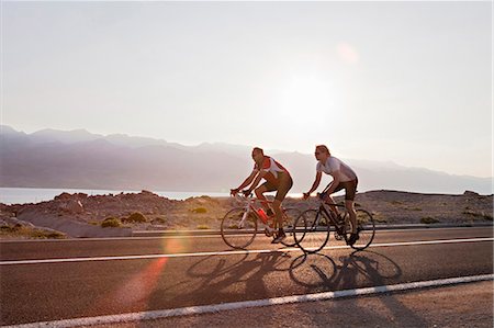 pic of human life cycle - Cyclists on country road by sea Stock Photo - Premium Royalty-Free, Code: 649-03511121