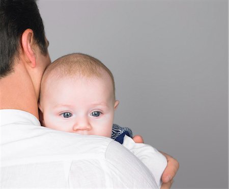 father with baby posing - Baby on fathers shoulder Stock Photo - Premium Royalty-Free, Code: 649-03511227