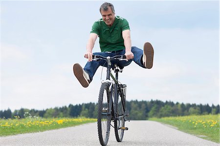 people balancing bicycle picture - Man riding bike Stock Photo - Premium Royalty-Free, Code: 649-03565995