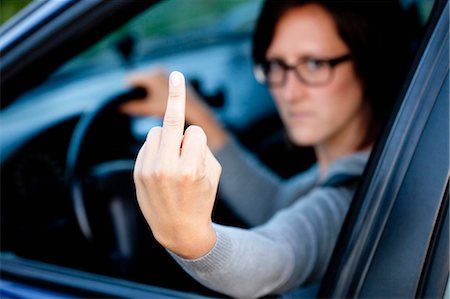 road rage - Woman showing bad gesture Stock Photo - Premium Royalty-Free, Code: 649-03566177