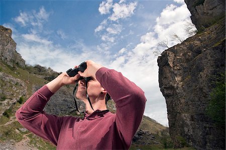 Man in valley with binoculars Stock Photo - Premium Royalty-Free, Code: 649-03566182