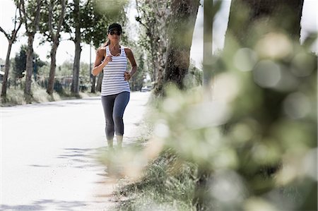 running music woman - Woman jogging on a street Stock Photo - Premium Royalty-Free, Code: 649-03566509