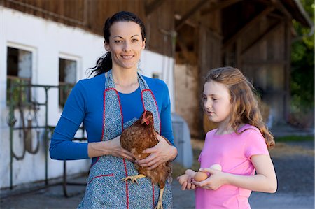 egg and farm - Farmwoman with hen, daughter with eggs Stock Photo - Premium Royalty-Free, Code: 649-03566577