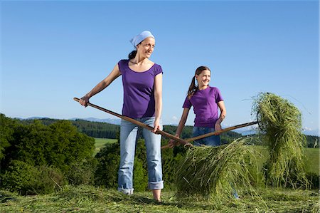 Mother, daughter collecting grass Stock Photo - Premium Royalty-Free, Code: 649-03566589