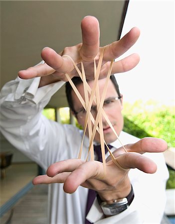 simsearch:693-06020309,k - Man stretches elastic bands Stock Photo - Premium Royalty-Free, Code: 649-03567039