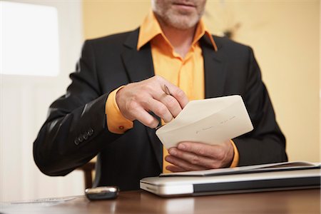 Man opening letter Stock Photo - Premium Royalty-Free, Code: 649-03606188