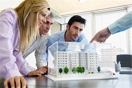 four hands - People studying architectural model Stock Photo - Premium Royalty-Free, Code: 649-03606304