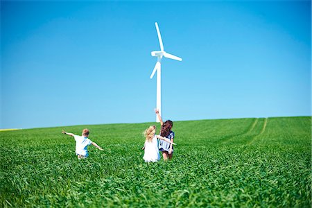 plane kid playing - Wind turbine and childrens play in field Stock Photo - Premium Royalty-Free, Code: 649-03621504